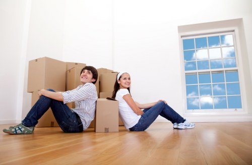 Moving team handling boxes and furniture during a local relocation