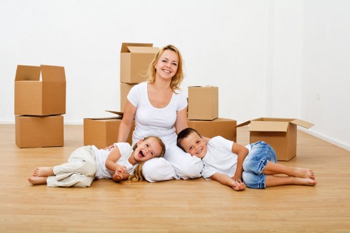 Professional movers handling household items near West Heath homes