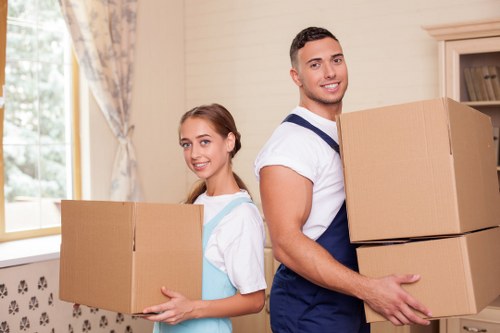Local movers handling fragile items with protective packing materials