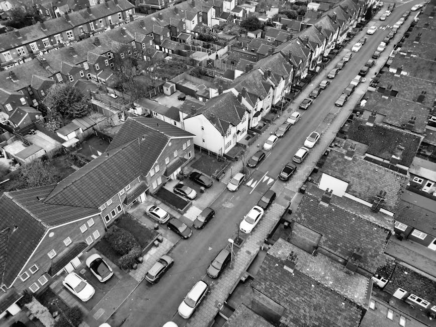 A designated accessible parking space in an outdoor car park, featuring yellow painted lines and a large wheelchair symbol marked on dark asphalt. The space is empty, with no vehicles present, and the painted lines are clearly visible. In the background, part of the adjacent parking spaces with similar yellow markings can be seen. The scene is well-lit, with natural daylight illuminating the area. This parking space is relevant to house removals and home relocation services provided by Man with Van West Heath, highlighting the importance of accessible parking for moving day logistics and safe furniture transport.